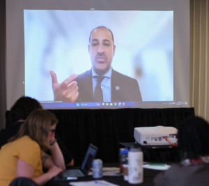 Speaker delivers keynote speech on screen